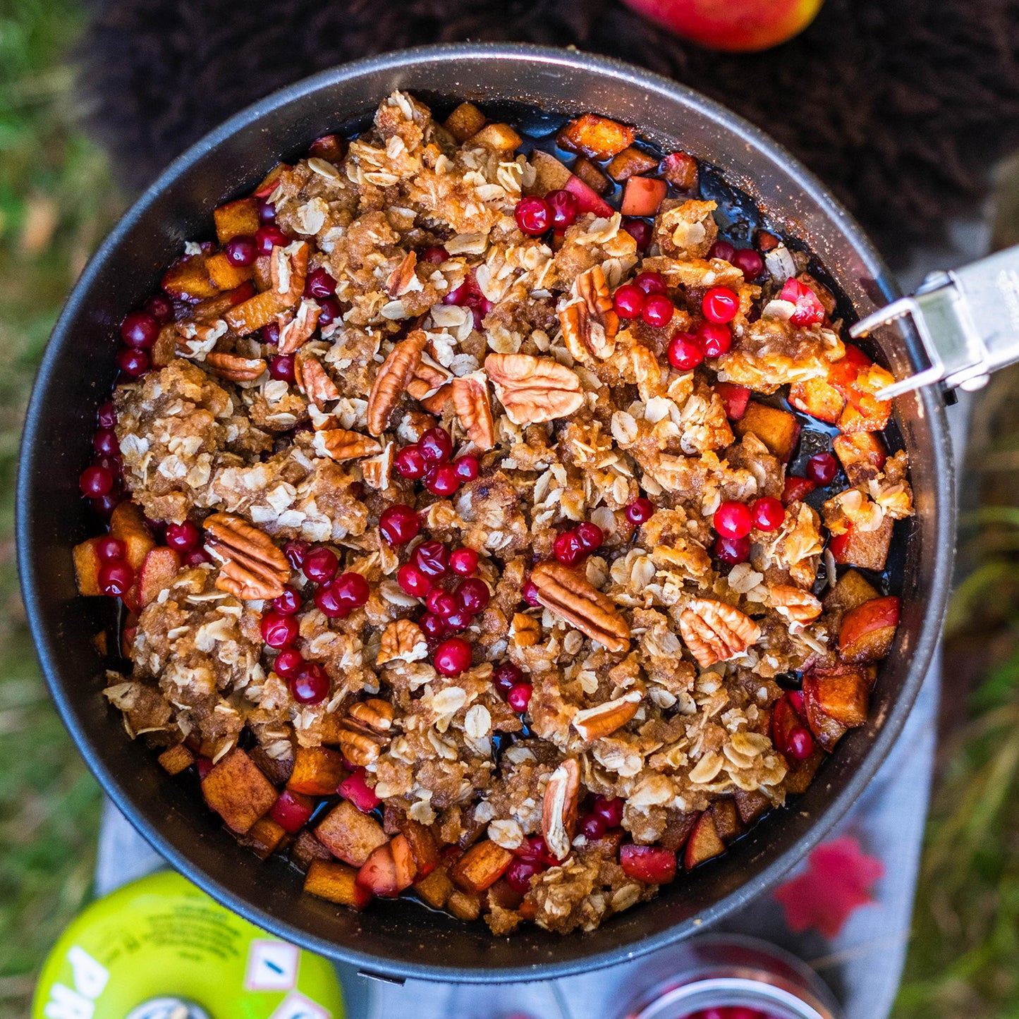 apple crumble with lingonberries on camping stove